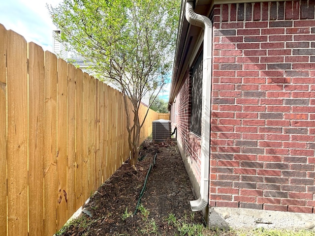 view of side of property with central air condition unit