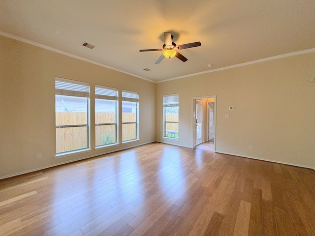 empty room featuring crown molding, ceiling fan, and light wood-type flooring