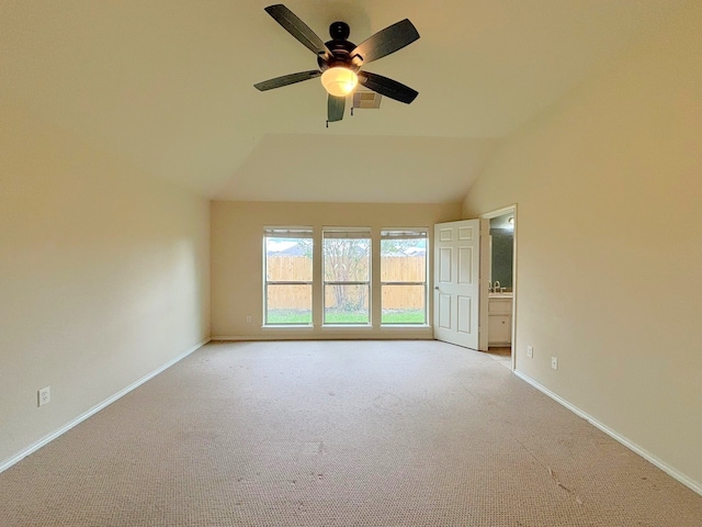 carpeted empty room with vaulted ceiling and ceiling fan