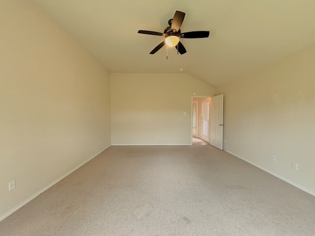 carpeted spare room with lofted ceiling and ceiling fan