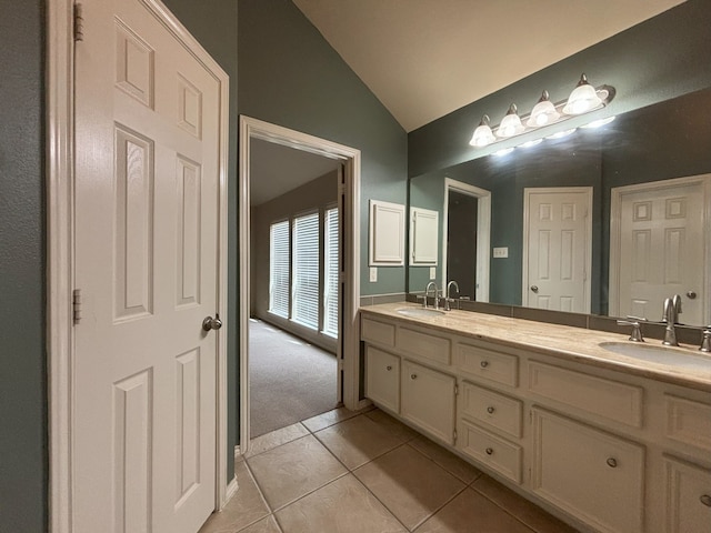 bathroom featuring vanity, vaulted ceiling, and tile patterned flooring