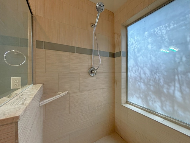 bathroom featuring a tile shower