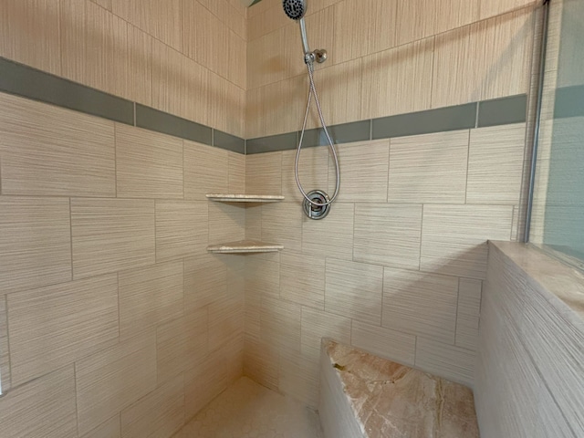 interior details featuring tiled shower