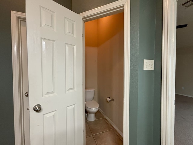 bathroom featuring toilet and tile patterned flooring