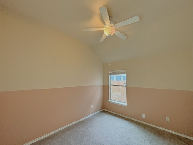 carpeted empty room featuring lofted ceiling and ceiling fan