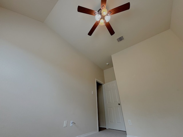 spare room featuring lofted ceiling and ceiling fan