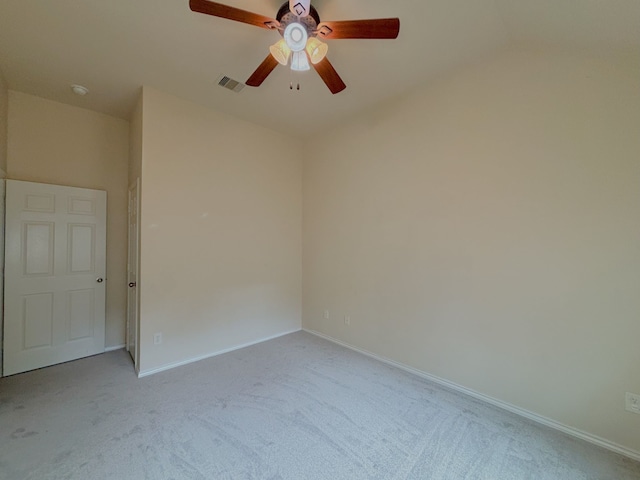 spare room featuring ceiling fan and light colored carpet