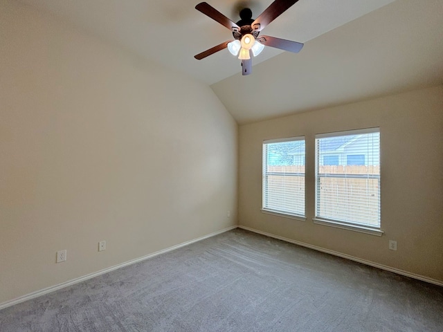 carpeted spare room with lofted ceiling and ceiling fan