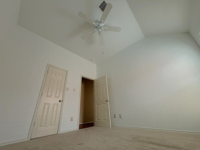 carpeted spare room featuring lofted ceiling and ceiling fan