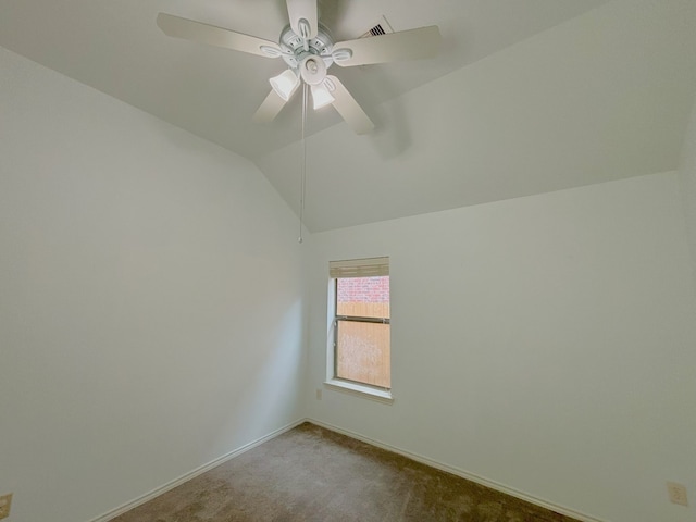 carpeted empty room featuring lofted ceiling and ceiling fan