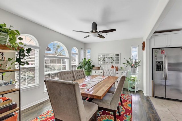 dining space with light hardwood / wood-style flooring and ceiling fan