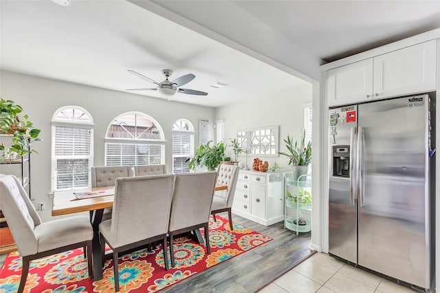 tiled dining area featuring ceiling fan