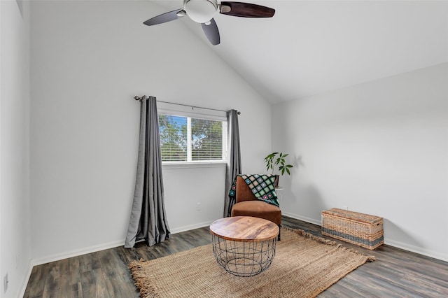 living area featuring high vaulted ceiling, ceiling fan, and dark wood-type flooring