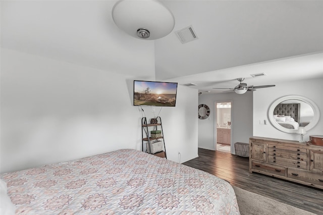 bedroom with ceiling fan, dark wood-type flooring, and connected bathroom