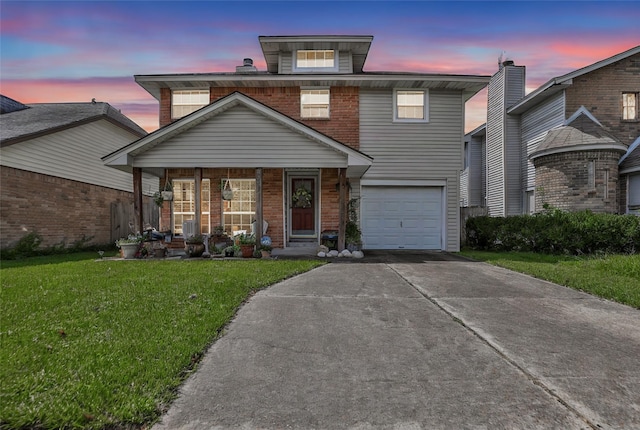 front of property featuring a garage and a yard