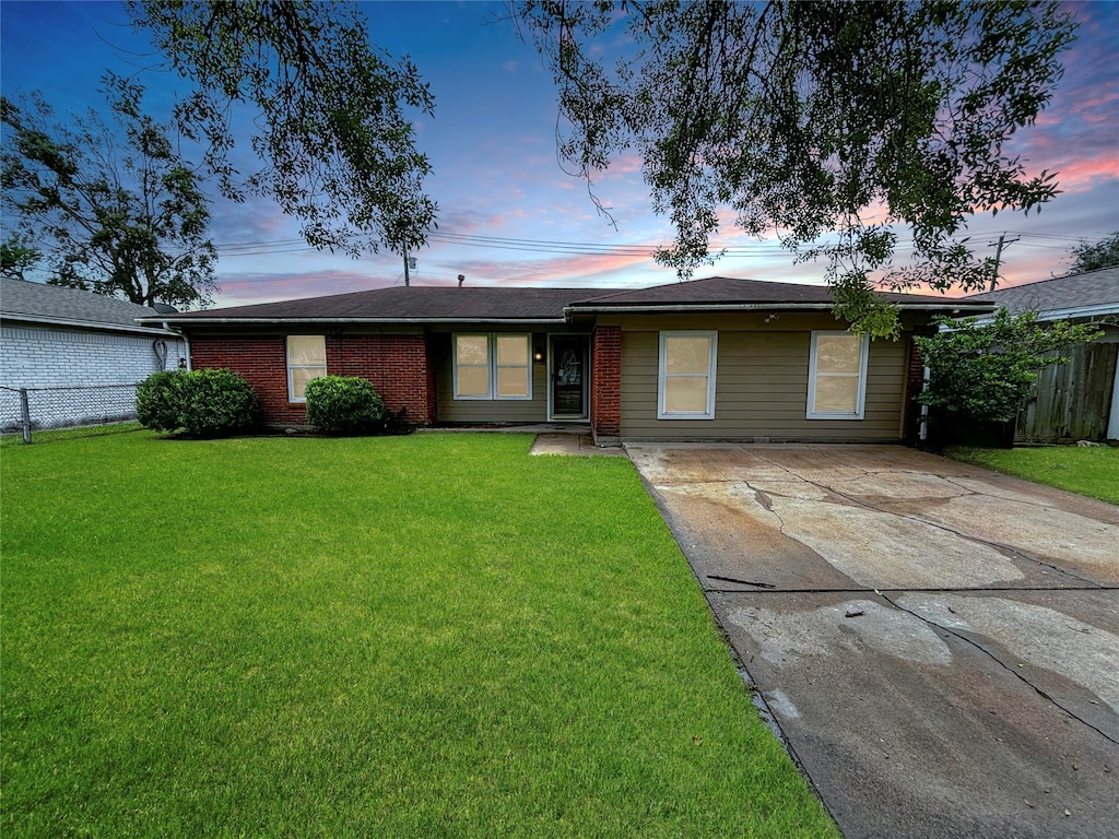 ranch-style house featuring a yard