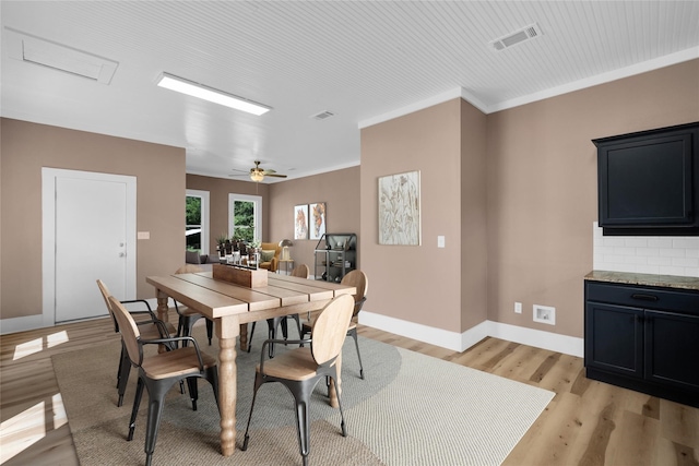 dining area featuring crown molding, ceiling fan, and light hardwood / wood-style floors