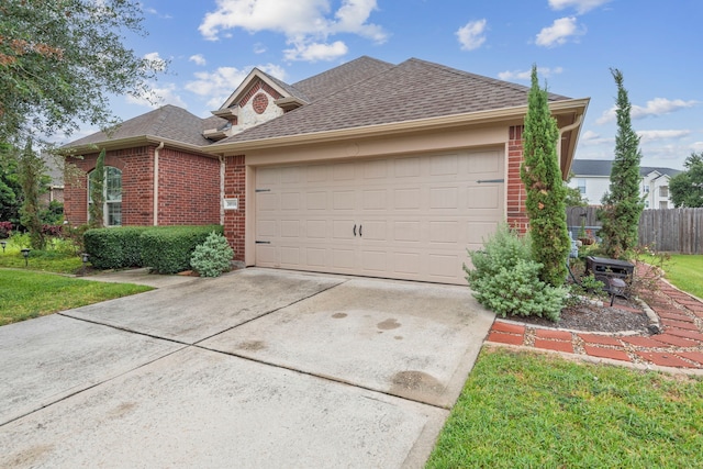 view of front of property with a front yard and a garage