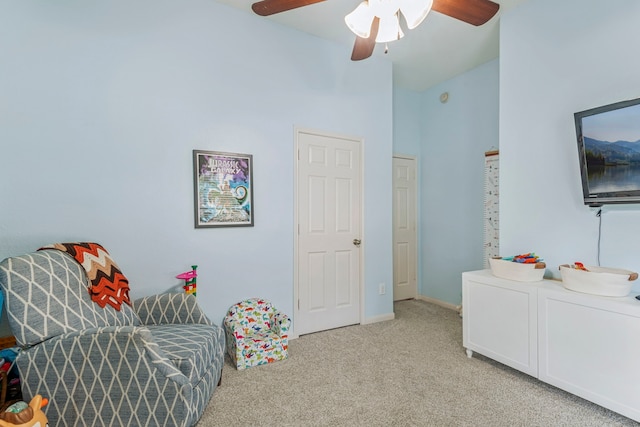 living area featuring a ceiling fan, baseboards, carpet floors, and high vaulted ceiling