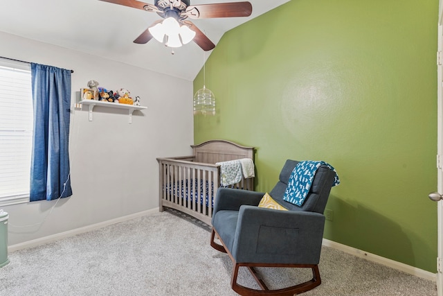 bedroom featuring baseboards, carpet floors, ceiling fan, vaulted ceiling, and a nursery area