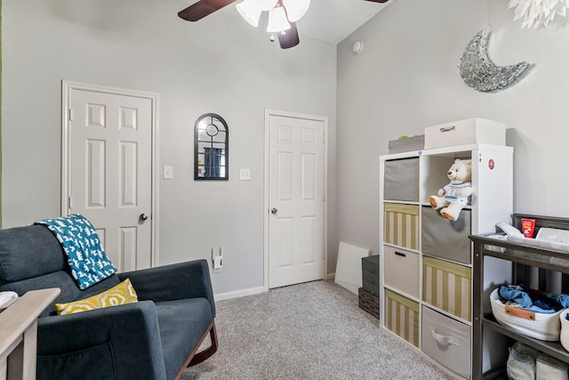 living area with baseboards, carpet floors, and ceiling fan