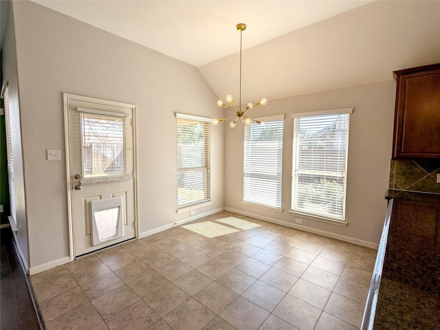 unfurnished dining area featuring light tile patterned floors, baseboards, lofted ceiling, and a chandelier