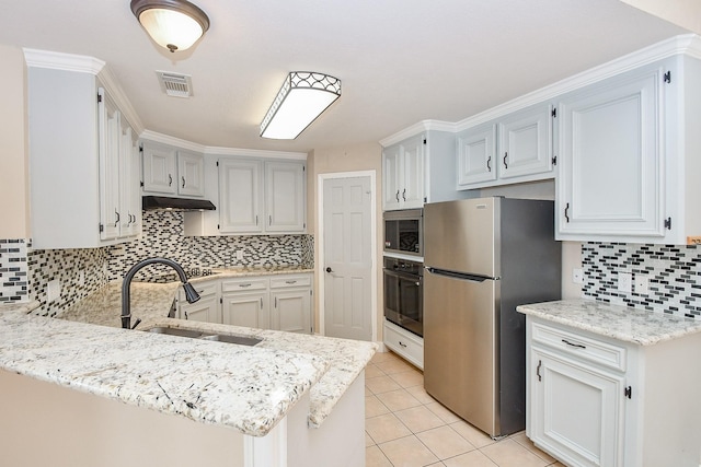 kitchen featuring sink, light tile patterned floors, stainless steel appliances, white cabinets, and kitchen peninsula