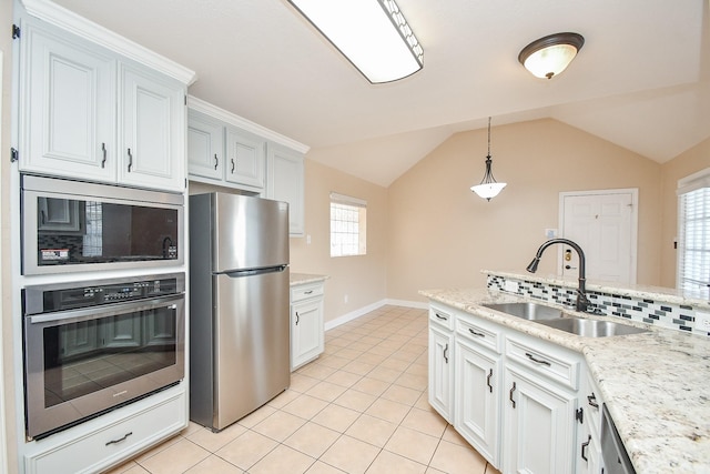 kitchen featuring sink, hanging light fixtures, white cabinets, and appliances with stainless steel finishes