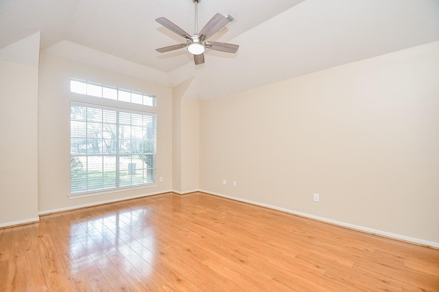 unfurnished room with lofted ceiling, ceiling fan, and light hardwood / wood-style flooring