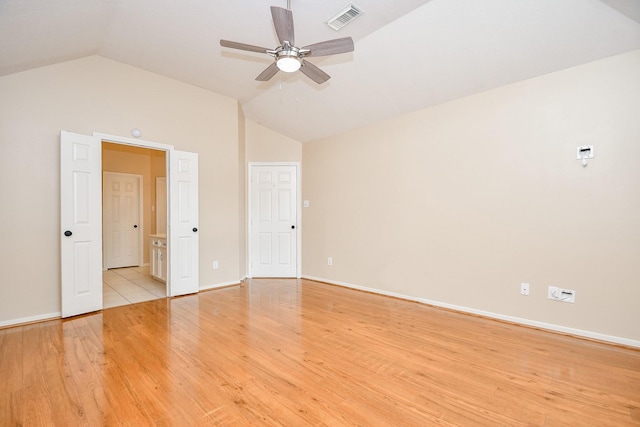 spare room with light hardwood / wood-style flooring, ceiling fan, and vaulted ceiling