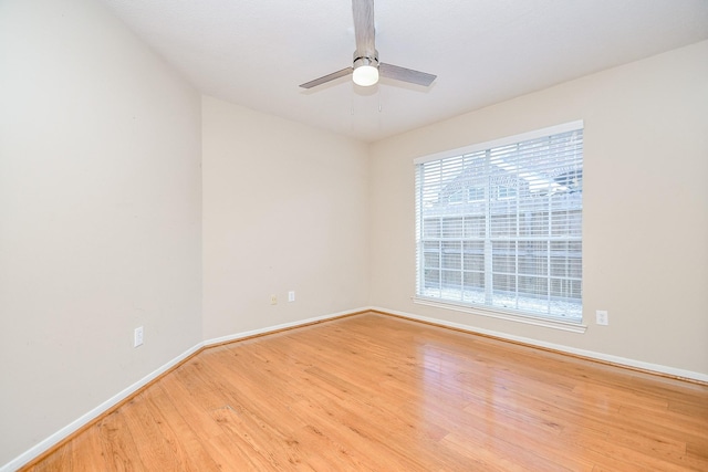 spare room featuring light hardwood / wood-style floors and ceiling fan