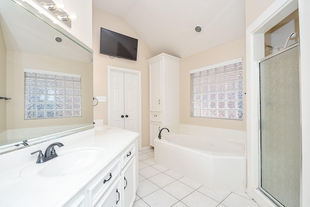 bathroom featuring tile patterned floors, vanity, separate shower and tub, and vaulted ceiling