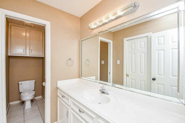 bathroom featuring tile patterned flooring, vanity, and toilet