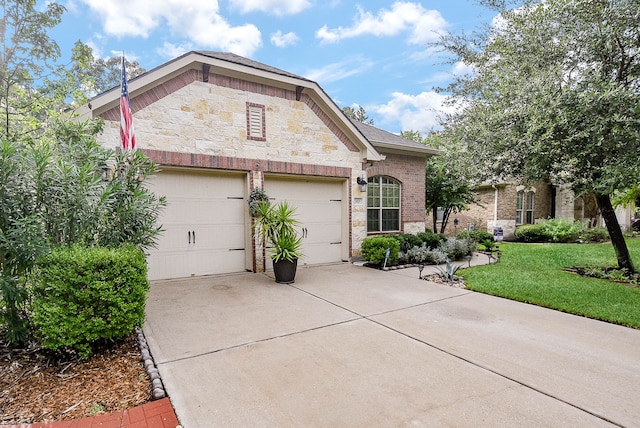 view of front of home with a front yard and a garage