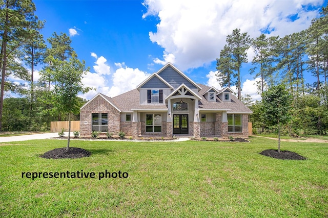 40858 Community Rd, Magnolia, TX 77354 - craftsman house featuring french doors, a front yard, brick siding, and roof with shingles