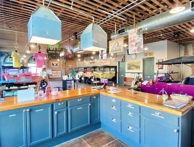 2127 Broadway St, Galveston, TX 77550 - kitchen with visible vents, blue cabinets, and butcher block counters