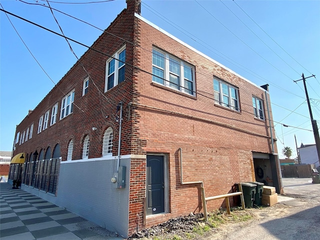 2127 Broadway St, Galveston, TX 77550 - view of property exterior featuring a chimney and brick siding