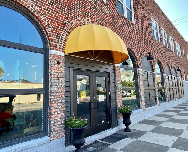 2127 Broadway St, Galveston, TX 77550 - view of exterior entry featuring brick siding and french doors