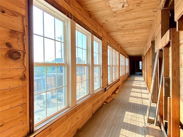 2127 Broadway St, Galveston, TX 77550 - hallway featuring hardwood / wood-style floors, wood walls, and wooden ceiling