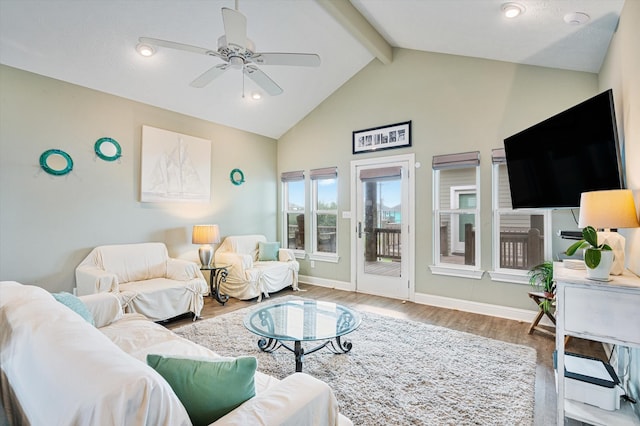 living room with hardwood / wood-style floors, ceiling fan, and vaulted ceiling with beams