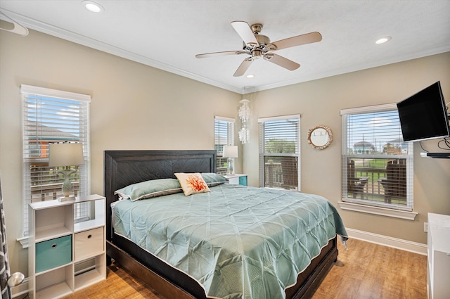 bedroom with ceiling fan, light hardwood / wood-style floors, and ornamental molding