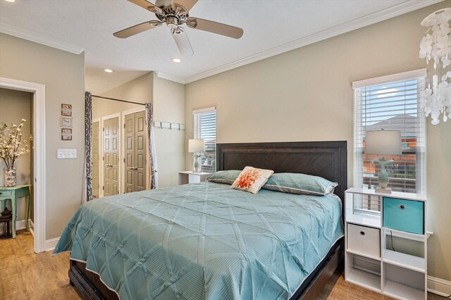 bedroom featuring ornamental molding, multiple windows, and ceiling fan