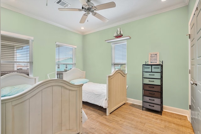 bedroom featuring ceiling fan, ornamental molding, and light hardwood / wood-style floors