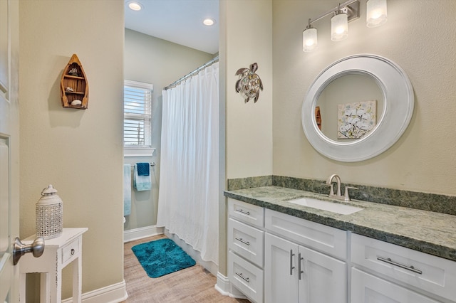 bathroom with vanity and hardwood / wood-style flooring