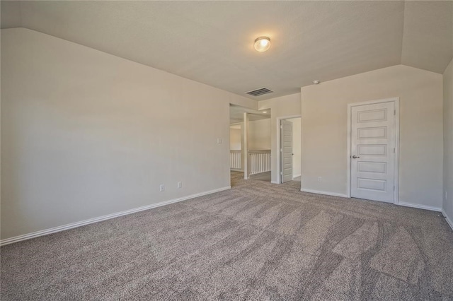 unfurnished bedroom with lofted ceiling, carpet floors, and a closet