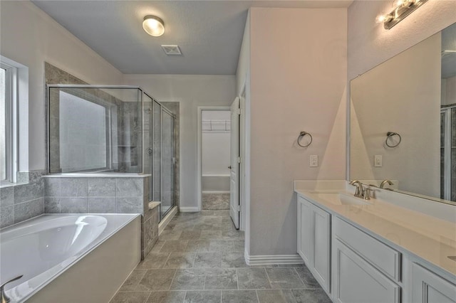 bathroom with vanity and independent shower and bath