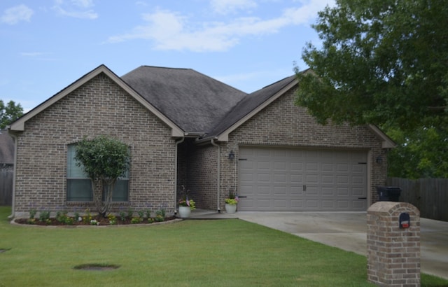 view of front of property featuring a front yard and a garage