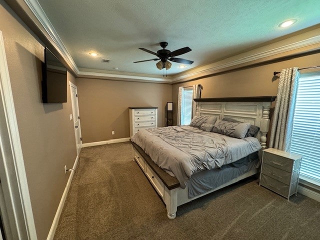 carpeted bedroom featuring a tray ceiling, ceiling fan, crown molding, and a textured ceiling