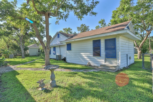 back of property featuring a yard and cooling unit