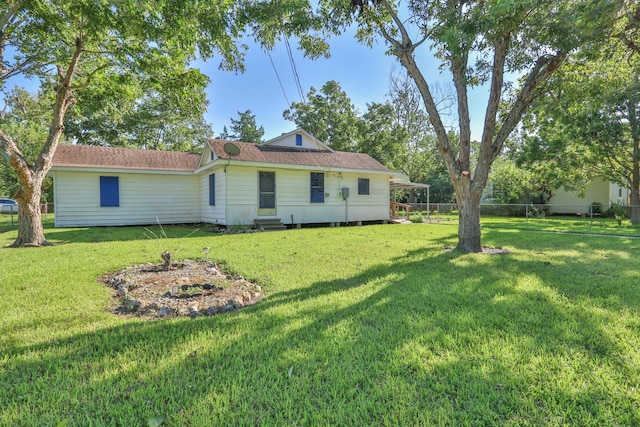 rear view of house with a lawn